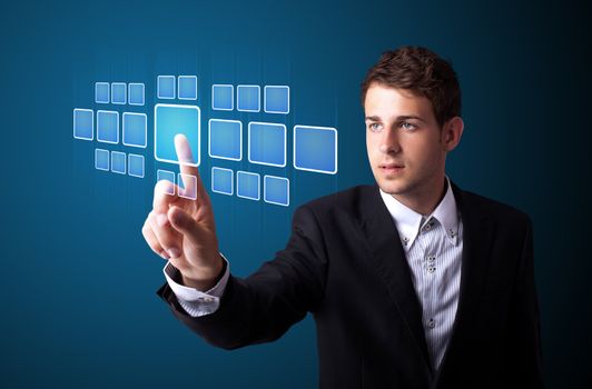 Businessman pressing high tech type of modern buttons on a virtual background