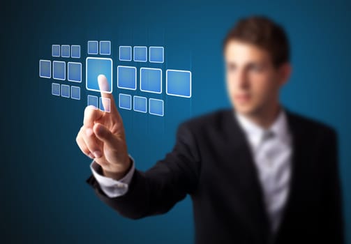 Businessman pressing high tech type of modern buttons on a virtual background