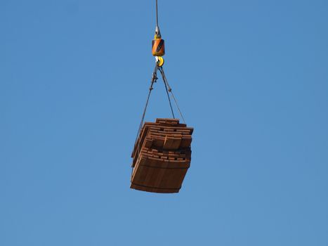 crane liting cargo of planks        