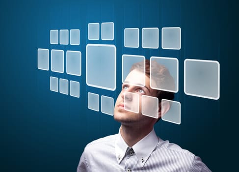 Businessman pressing high tech type of modern buttons on a virtual background