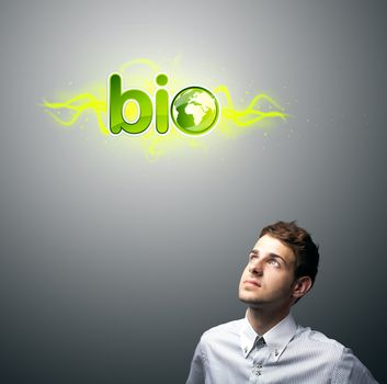 Young businessman holding virtual eco sign