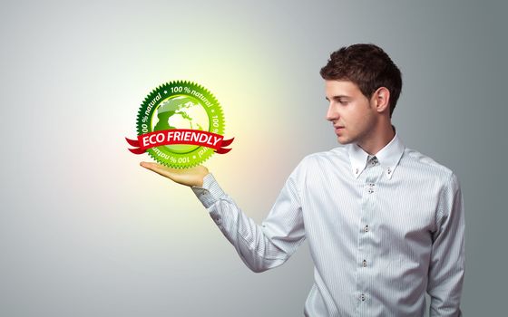 Young businessman holding virtual eco sign