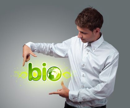 Young businessman holding virtual eco sign