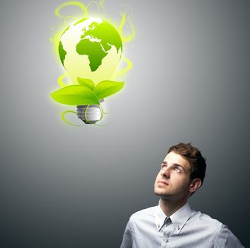 Young businessman holding virtual eco sign