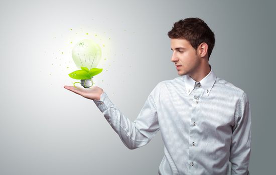 Young businessman holding virtual eco sign