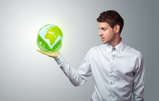 Young businessman holding virtual eco sign