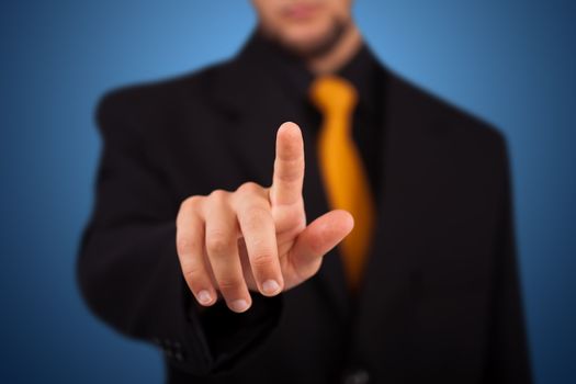 Businessman pressing an imaginary button on bokeh 