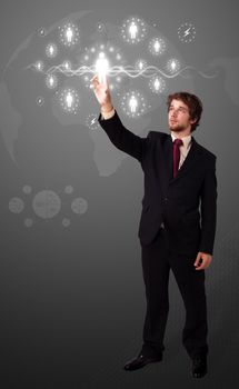 Businessman pressing modern social buttons on a virtual background