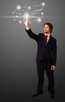 Businessman pressing modern social buttons on a virtual background