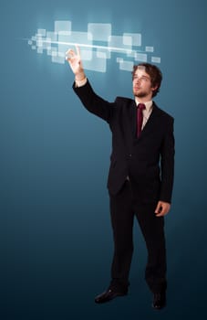 Businessman pressing high tech type of modern buttons on a virtual background