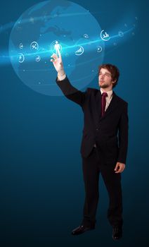 Businessman pressing modern social buttons on a virtual background