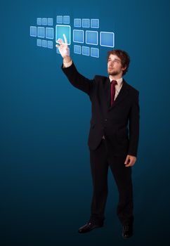 Businessman pressing high tech type of modern buttons on a virtual background