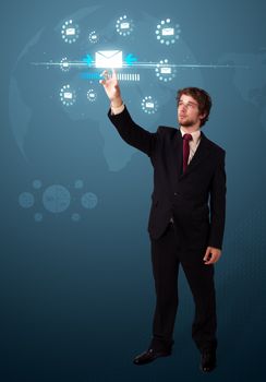 Businessman pressing messaging type of modern icons with virtual background