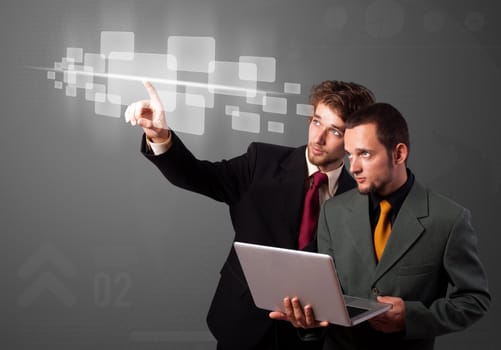 Businessman pressing high tech type of modern buttons on a virtual background