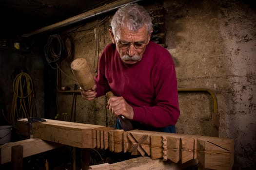 Old woodcarver work in the workshop 1