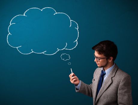 Attractive young man smoking cigarette with idea cloud