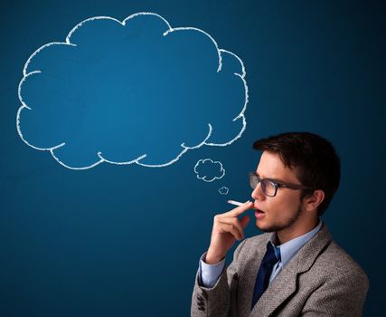 Attractive young man smoking cigarette with idea cloud