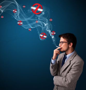 Attractive young man smoking dangerous cigarette with no smoking signs