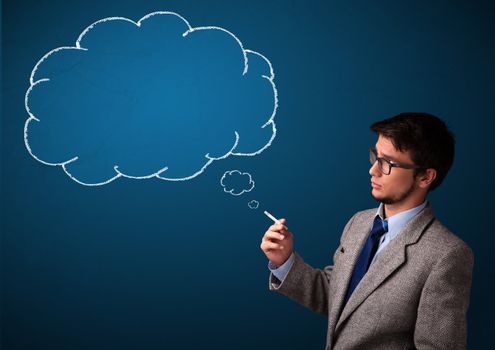 Attractive young man smoking cigarette with idea cloud