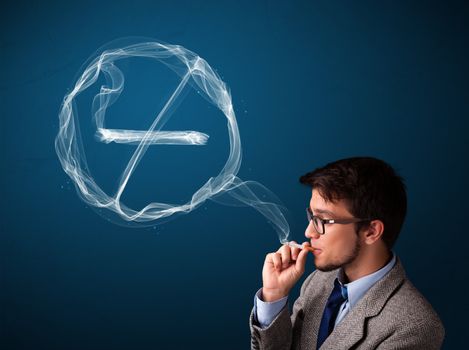 Handsome young man smoking unhealthy cigarette with no smoking sign
