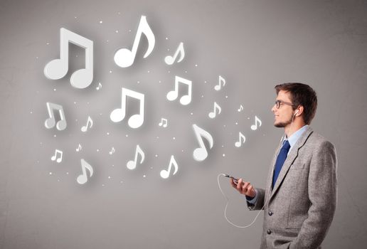 attractive young man singing and listening to music with musical notes getting out of his mouth