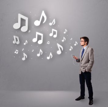 attractive young man singing and listening to music with musical notes getting out of his mouth