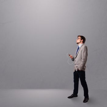 handsome young man singing and listening to music with copy space
