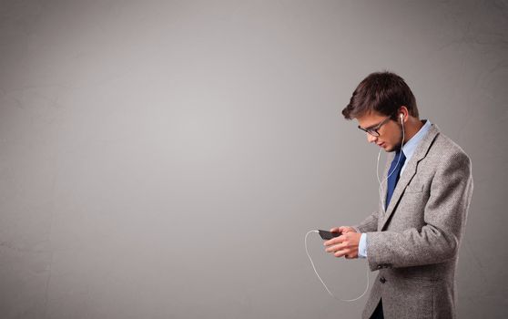 handsome young man singing and listening to music with copy space