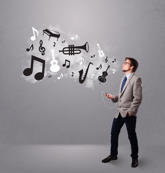 attractive young man singing and listening to music with musical notes and instruments getting out of his mouth