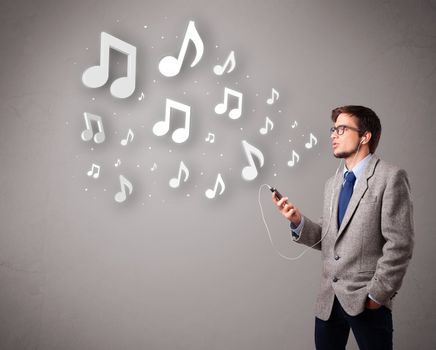 attractive young man singing and listening to music with musical notes getting out of his mouth