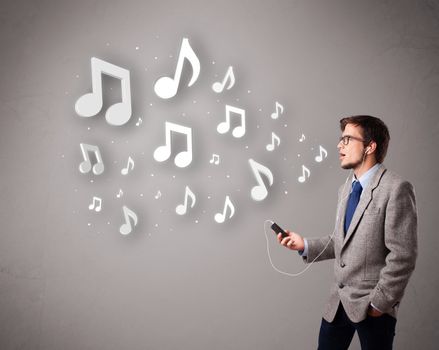 attractive young man singing and listening to music with musical notes getting out of his mouth