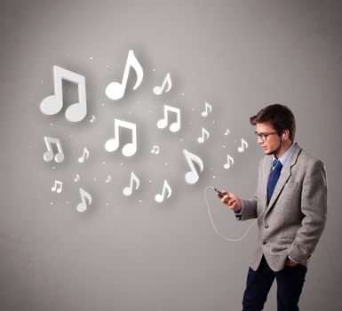 attractive young man singing and listening to music with musical notes getting out of his mouth