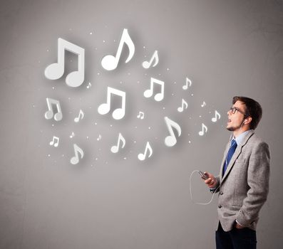 attractive young man singing and listening to music with musical notes getting out of his mouth