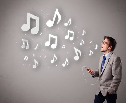 attractive young man singing and listening to music with musical notes getting out of his mouth