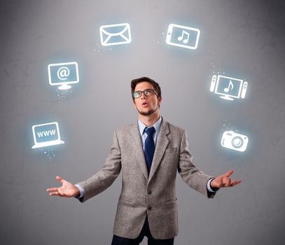 funny boy standing and juggling with electronic devices icons
