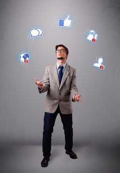 handsome boy standing and juggling with social media icons