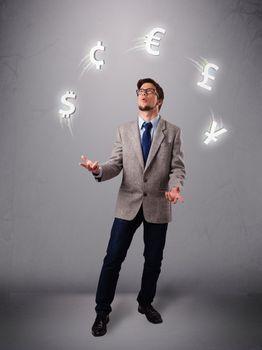 Attractie young man standing and juggling with currency icons