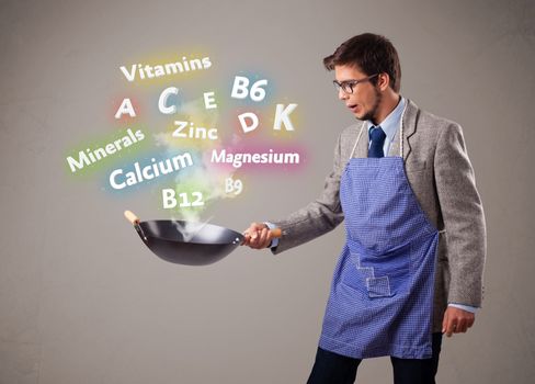 Handsome man cooking vitamins and minerals