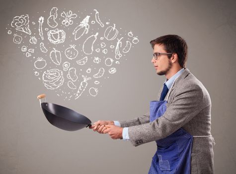 Attractive young man cooking vegetables