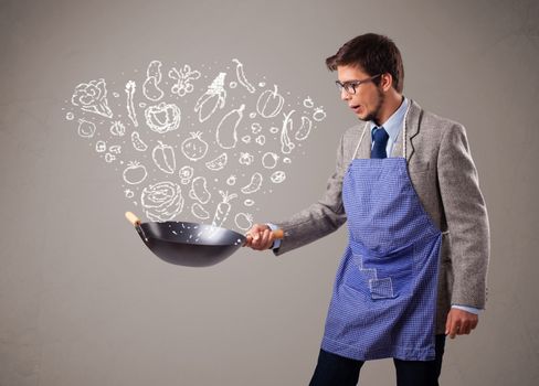 Attractive young man cooking vegetables