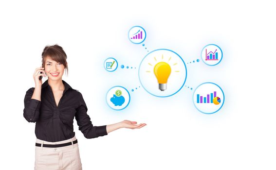 Young woman presenting light bulb with colorful graphs and diagrams isolated on white
