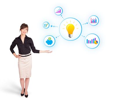 Young woman presenting light bulb with colorful graphs and diagrams isolated on white