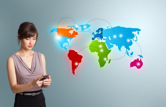 Beautiful young woman holding a phone and presenting colorful world map