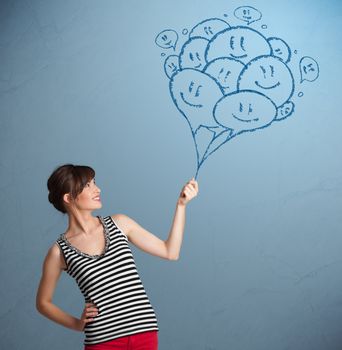 Happy young woman holding smiling balloons drawing