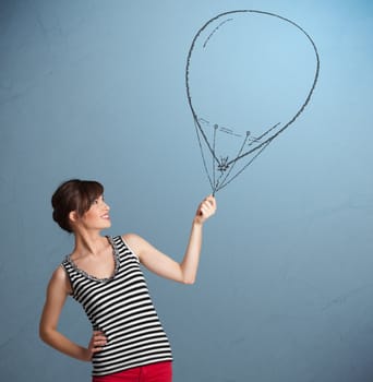 Beautiful young woman holding balloon drawing
