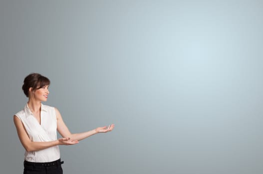 Pretty young woman presenting copy space