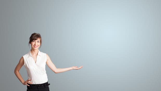 Pretty young woman presenting copy space