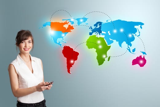 Beautiful young woman holding a phone and presenting colorful world map