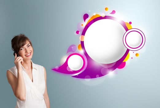 Pretty young woman presenting abstract speech bubble copy space and making phone call