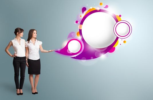 Attractive young women presenting abstract speech bubble copy space